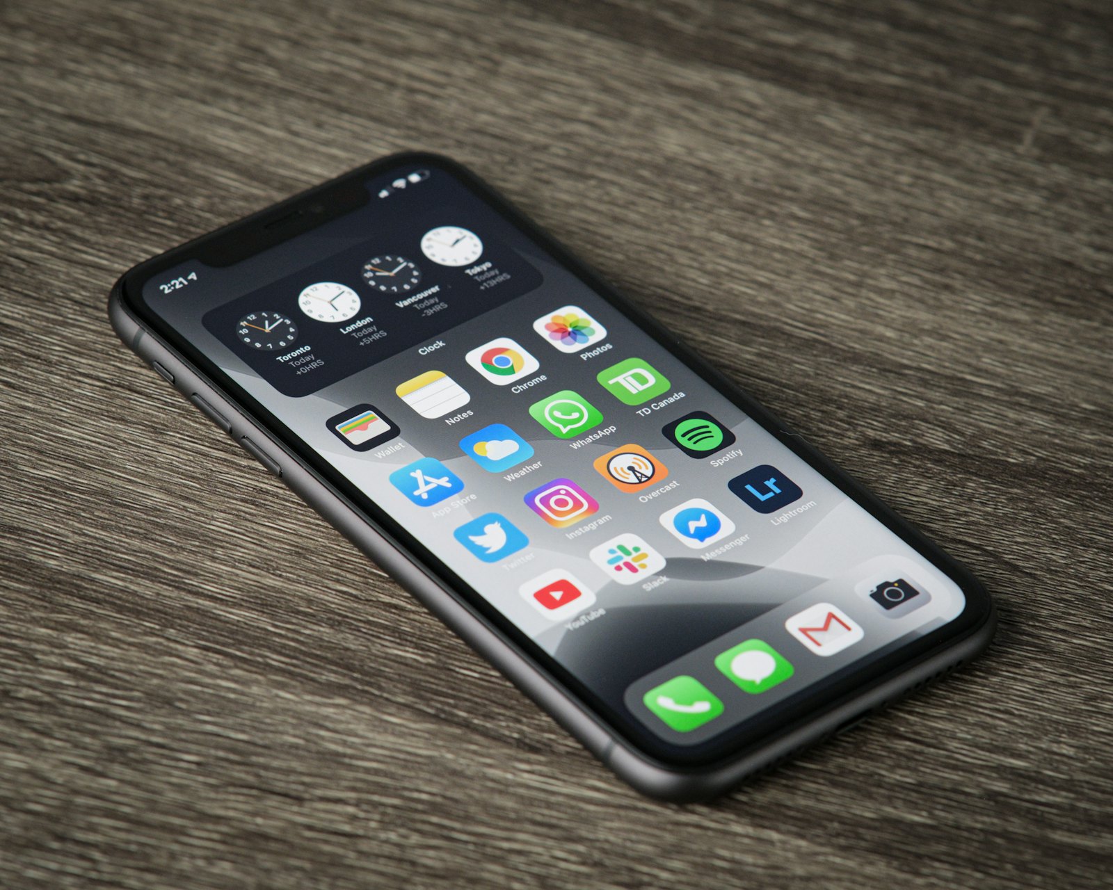 Smartphone on a desk with Instagram, YouTube and other social apps on the home screen